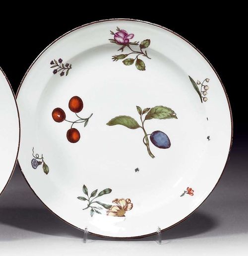 PLATE WITH WOOD CUT DECORATION, Meissen, circa 1745.Painted with cherries, a plum and scattered wood cut flowers. The smooth sides painted brown. Underglaze blue sword mark, impressed number 22. D 23.3cm. Minor rubbing.