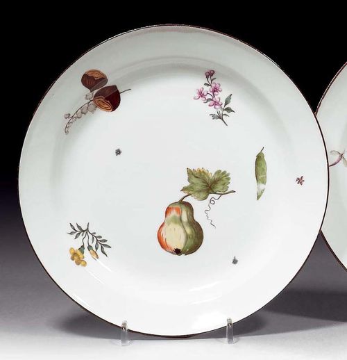 PLATE WITH WOOD CUT DECORATION, Meissen, circa 1745.Painted with a pear on a branch, two hazel nuts and wood cut flowers. With brown-painted edge. Underglaze blue sword mark, impressed number 22. D 22.3cm. Minor rubbing. Provenance: from a private collection, Solothurn