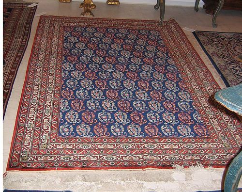 GHOM, old. Dark blue central field, diagonal patterning with Boteh motifs, red and white border, good condition, 212x142 cm.