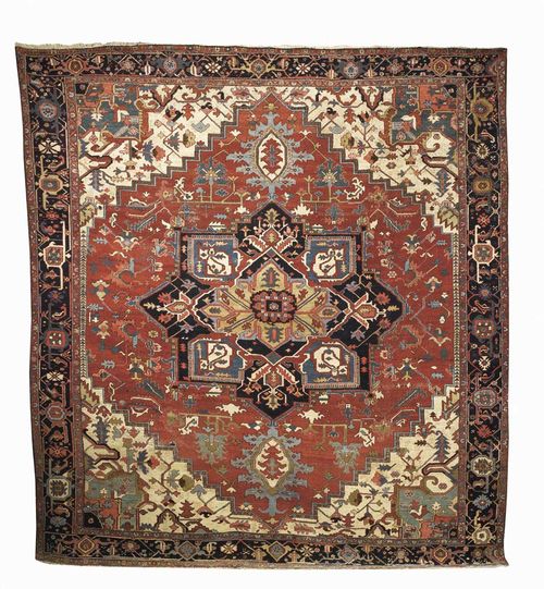 HERIZ antique. Black central medallion on red ground with white corner motifs, geometric patterned throughout. Black border. Considerable wear.  350x327 cm.