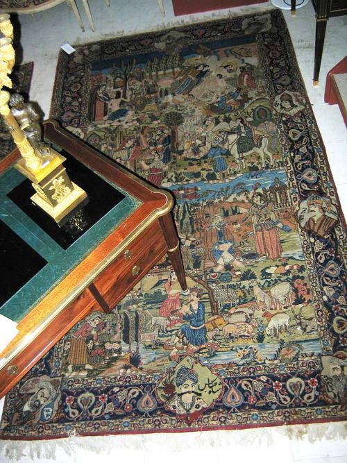 ISFAHAN PICTORIAL CARPET old. With paradisical landscapes with figures, animals and plants, blue border with portraits and stylised trailing flowers. Slight wear otherwise good condition.  275x165 cm.