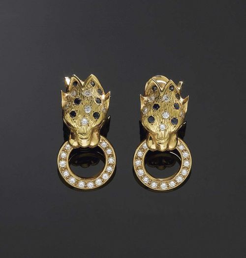 SAPPHIRE, RUBY AND BRILLIANT-CUT DIAMOND CLIP EARRINGS Yellow gold 750. With lion head motifs, decorated with 22 sapphires and 4 rubies totalling ca. 1.00 ct also 38 brilliant-cut diamonds totalling ca. 1.45 ct..