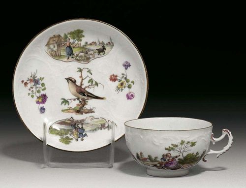 PAIR OF SMALL CUPS AND SAUCERS, Meissen, mid 18th century. With rocaille decoration in relief, painted with landscape scenes and figures between small flower bouquets and bird vignettes, rim edged in brown, crossed swords in underglaze-blue, impressed numerals.