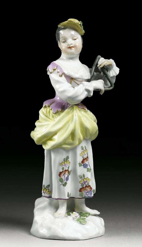 GIRL WITH TRIANGLE, Meissen, mid 18th century. Model in the manner of J.J.Kändler. Standing with a triangle in her left hand, crossed swords in underglaze-blue, impressed numeral 2, 13,3cm, small restorations.