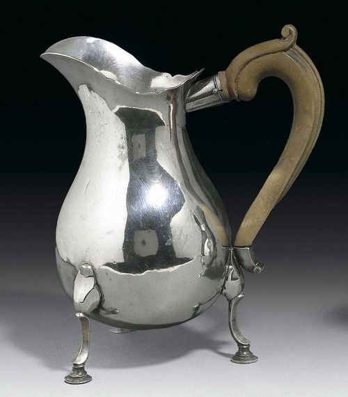 CREAM JUG. Neuenburg circa 1750. With maker's mark. On 3 scrolled feet, with shaped wooden handle. H 16 cm, 220 g.