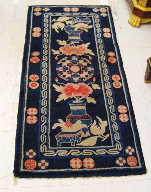 PAOTOU old. Blue ground with round central medallion and 2 vases. Narrow border. Good condition. 134x65 cm.