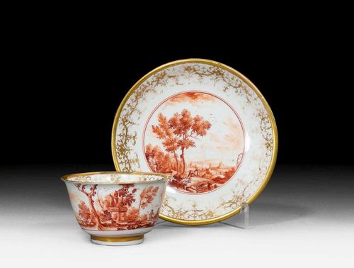 SMALL CUP AND SAUCER WITH LANDSCAPE IN IRON RED, Meissen, circa 1725. Fine landscape with figures in iron red and camaïeu. Gold border. Underglaze blue sword mark with shaped blades. Gold number 61, potter's mark  /. Cup restored. Gilding rubbed. Provenance: from a private collection, Solothurn.