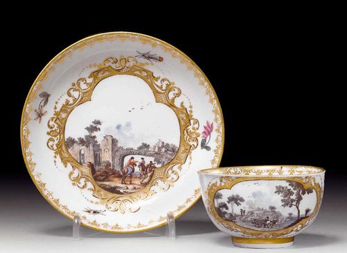 CUP AND SAUCER WITH LANDSCAPE CARTOUCHES, Meissen, circa 1745.The landscapes in lattice cartouches heightened in black. Also with insects and Deutsche Blumen. Underglaze blue sword mark, impressed number, gold mark on the cup. The scenes blackened during firing. Provenance: from a private collection, Solothurn