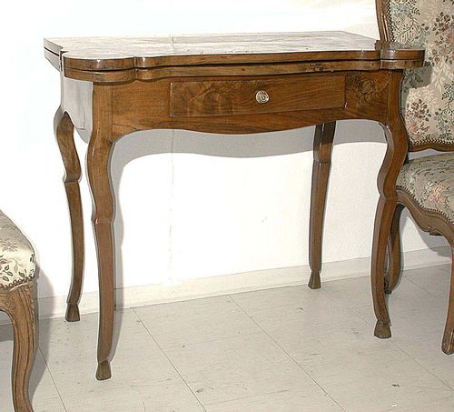 GAMES TABLE, Louis XV, Bern circa 1770. Walnut and burlwood in veneer. The hinged top lined inside with green gold-stamped leather. With salient angles for candle holders, 1 front drawer, shaped legs and hoof feet. The top with oval depressions for counters. 88x44x(open 88)x76 cm. A refined table in very good condition