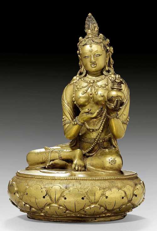 A GILT COPPER FIGURE OF YESHE TSOGYAL SITTING ON A ROUND BASE. Mongolia, Zanabazar school, 17th/18th c. Height 18 cm.