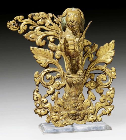 A GILT COPPER REPOUSSÉ LION EMERGING FROM LOTOS SCROLLS. Tibet, 18th/19th c. Height 20.5 cm.