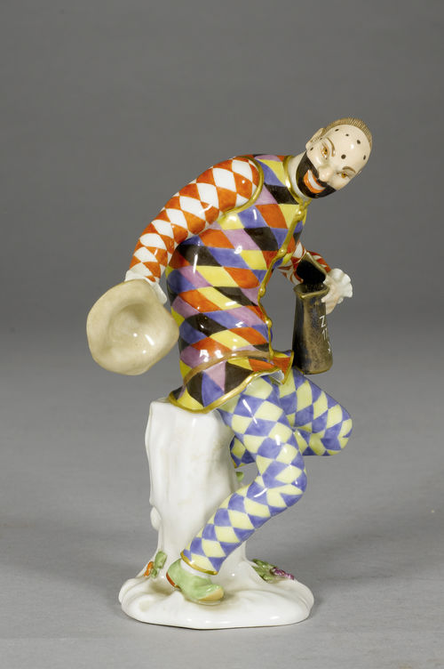 A HARLEQUIN WITH A LIDDED JUG,