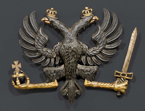 CARVED DOUBLE EAGLE,Baroque, German, 18th century. Carved, polychrome painted and parcel gilt wood. Double eagle with crown, imperial orb and sword. H 35 cm, W 45 cm.