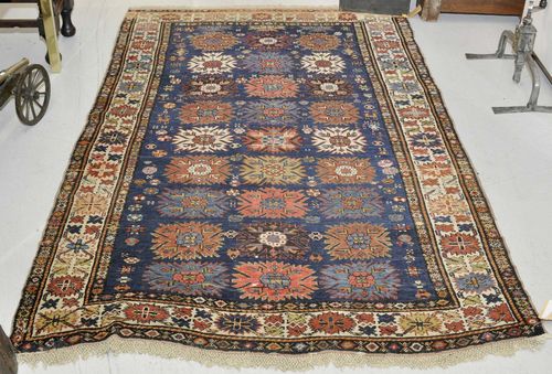 DAGESTAN antique.Blue central field patterned throughout with star motifs, white edging, restored, 148x230 cm.