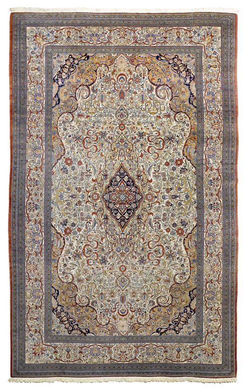 GHOM old.White ground with a black central medallion, opulently patterned with trailing flowers in harmonious colours, white edging, signs of wear, 345x530 cm.