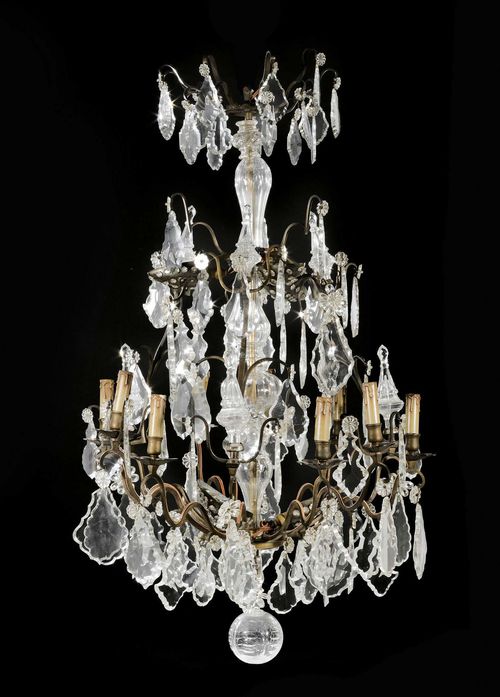 BASKET CHANDELIER,Louis XV style, Paris, late 19th century. Bronze with cut glass and crystal hangings. 12 light branches. Fitted for electricity. H approx. 110 cm, W 75 cm. Provenance: from a highly important Swiss private collection.