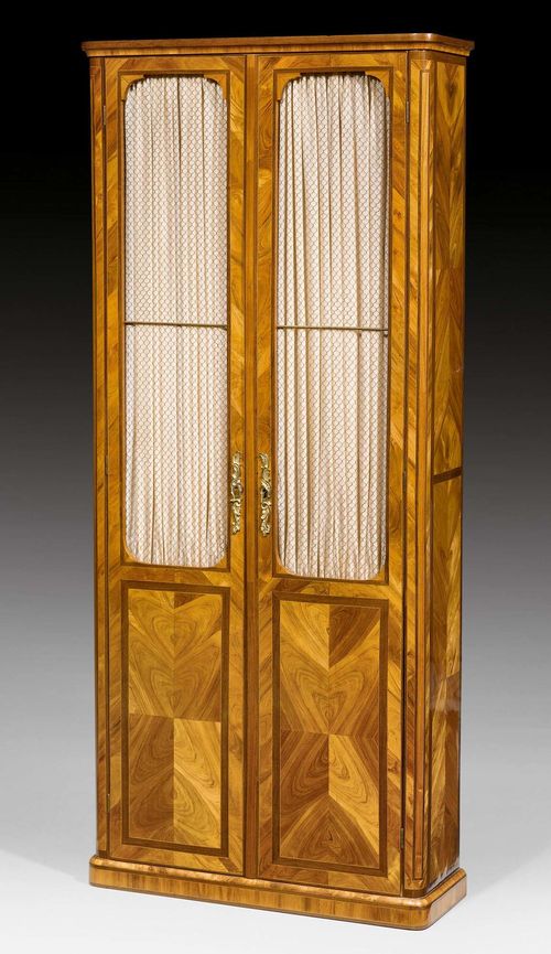 NARROW LIBRARY VITRINE,Louis XVI, in the style of F. LELEU (Jean-Francois Leleu, maitre 1764), Paris circa 1770. Tulipwood and amaranth in veneer, inlaid with reserves and fillets. The front with 2/3 latticed double doors. Gilt bronze mounts. 85x39x194 cm. Provenance: from a highly important Swiss private collection.