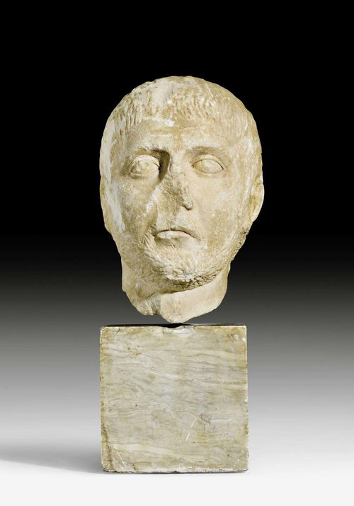 HEAD OF A SOLDIER,Roman, 4th century AD. Light marble. Mounted on cube base. H without base 26 cm, with base 41 cm. Provenance: - Sam Dormont, Tel Aviv. - Swiss private collection, acquired 1980.