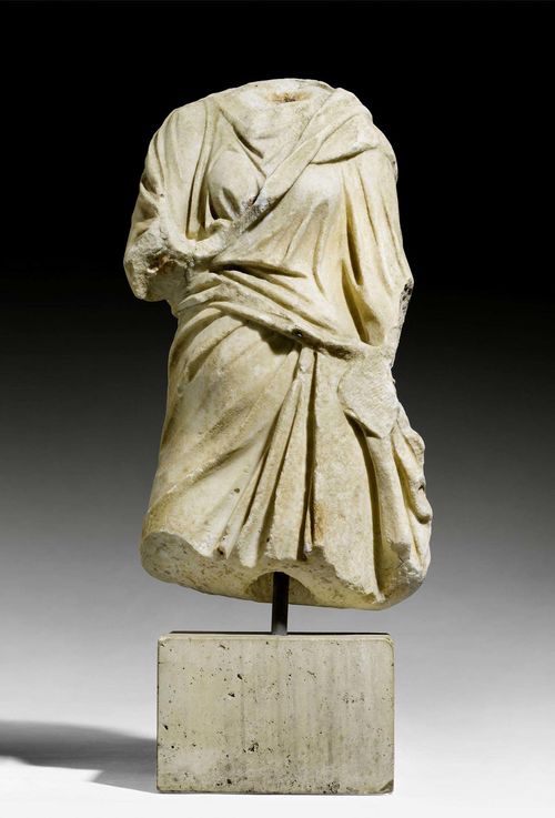 GARMENT STATUE OF A FEMALE DEITY,Roman, 2nd/3rd century AD. Light marble.  H without base 49 cm, with base 65 cm. Provenance: - Sam Dormont, Tel Aviv. - Swiss private collection, acquired 1980.