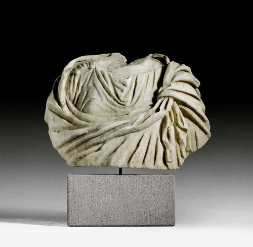 GARMENT STATUE,known as a "togatus", Roman, 2nd/3rd century AD. Light marble. Mounted on a concrete base. H without base 32 cm, with base 32 cm. W 41 cm. Provenance: - Sam Dormont, Tel Aviv. - Swiss private collection, acquired 1980.