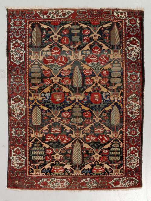 BACHTIAR old.Dark central field patterned with plant motifs, red edging with white floral cartouches, strong signs of wear, 147x200 cm.
