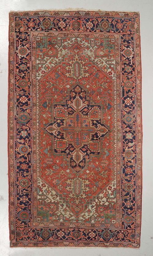 HERIZ antique.Red and white central field with a central medallion, typically patterned, black border with trailing flowers, signs of wear, 200x320 cm.