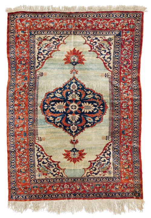 HERIZ SILK antique.Turquoise central field with a black central medallion and beige corner motifs, finely patterned with stylized plants, red edging with trailing flowers, in good condition, 138x195 cm.