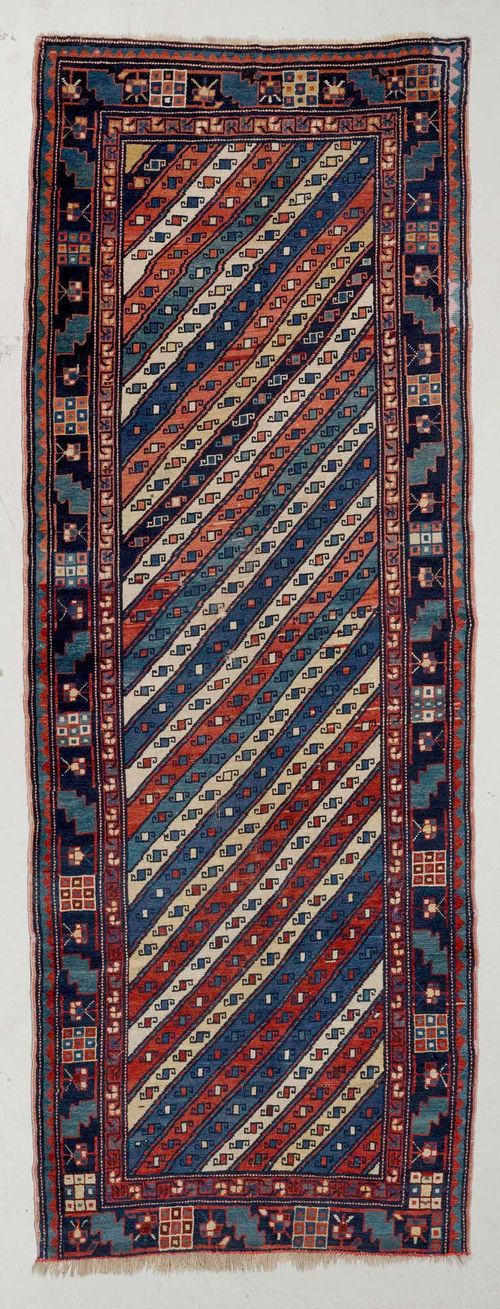 CAUCASIAN antique.Diagonally striped central field, geometrically patterned, blue border, signs of wear, 110x280 cm.