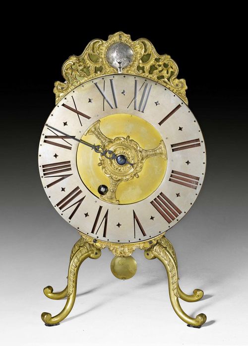 NIGHT CLOCK,known as a "veilleuse", Louis XV, the movement signed BLASER A BERN (Balthasar Blaser, active circa 1730), Bern circa 1730/40. Gilt, partly engraved bronze and brass. Pierced, revolving bronze chapter ring. With coat of arms of the VON TSCHARNER family at the top. Verge escapement with 4/4 striking on bell. 21x12x38 cm. Provenance: - Former Von Tscharner collection, Bern. - Private collection, Ticino. Illustrated in: J.O. Scherer, Antike Pendulen, Stuttgart o.J.; Table X.