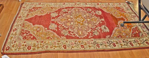 ANATOLIAN old.Red ground with a floral central medallion, white border with trailing flowers, good condition, 130x210 cm.