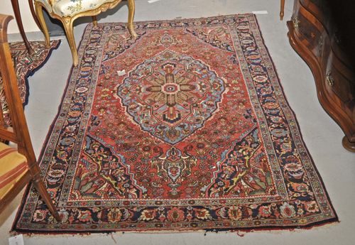 BIDJAR old.Red ground with a central medallion, patterned with stylized plant motifs, black border, signs of wear, 138x210 cm.