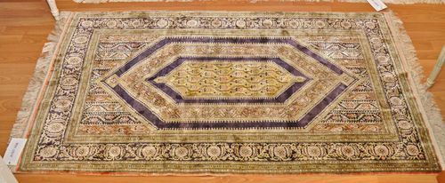 GHOM SILK.Vertically striped central field with a central medallion, patterned with stylized tendrils, black edging, 92x155 cm.