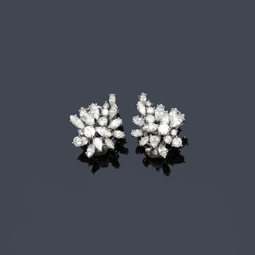 DIAMOND EAR CLIPS, E. MEISTER. White gold 750. Classic-elegant ear clips designed as a stylized flower, each set with 10 navette-cut diamonds, 2 drop-cut diamonds and 7 brilliant-cut diamonds, weighing ca. 3.00 ct. With case.