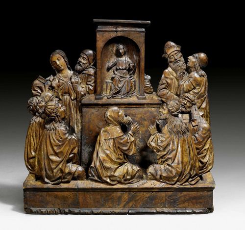 CHRIST AMONG THE SCRIBES, Flemish, beginning of the 17th century. Walnut, carved with remains of old paint . The centre with a raised niche of Jesus, with Mary and Joseph to the left of him, and other persons next to and in front of him. H 55, W 50 cm. 2 heads missing.