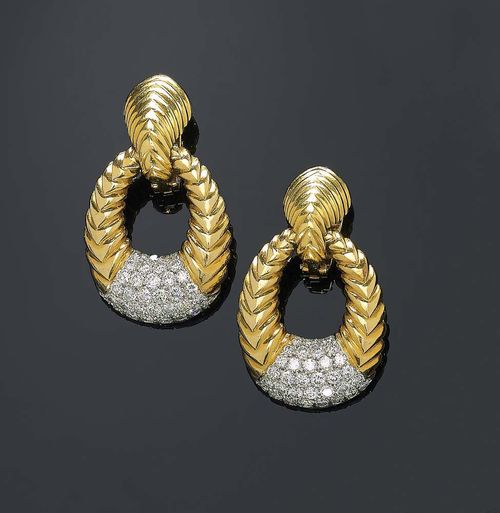 GOLD  AND BRILLIANT-CUT DIAMOND PENDANT EARRINGS. Yellow and white gold 750. Casual elegant large clip earring with a ribbed surface consisting of two oval rings on a movable mount, decorated with 66 brilliant-cut diamonds totalling ca. 2.7 ct. Matches the following lot.