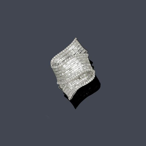 DIAMOND RING. White gold 750, 16g. Very decorative, fancy ring, the top designed as a folded band, set throughout with 5 rows of baguette-cut diamonds weighing ca. 7.00 ct with a brilliant-cut diamond border weighing ca. 0.70 ct. Size ca. 52.