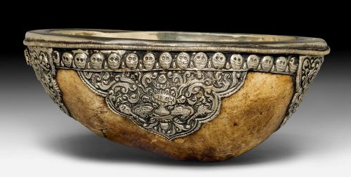 A SILVER LINED KAPALA DECORATED WITH CHASED SILVER.
