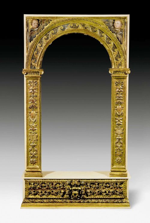 IMPORTANT DOOR FRAME,Baroque, Spain, 17th century. Finely carved giltwood with polychrome paint. Arched crown on molded square columns, base probably supplemented.  142x33x255 cm.