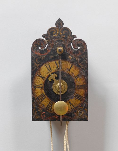 A SMALL IRON CLOCK WITH FRONT PENDULUM AND ALARM,