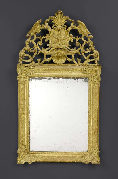 MIRROR,Baroque, northern Italy circa 1720. Pierced and richly carved giltwood. H 140 cm. W 80 cm.