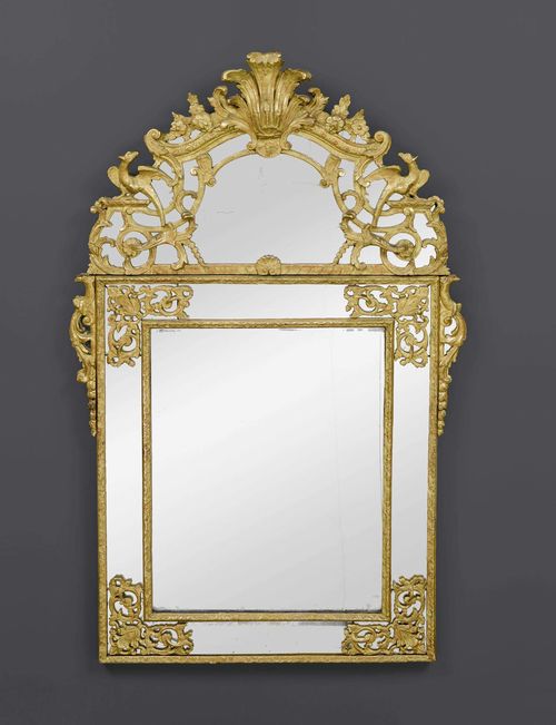 MIRROR,Regence, Paris circa 1720. Pierced and richly carved giltwood. H 149 cm. W 92 cm. Provenance: from a French collection. Exceptionally fine mirror of high quality; expertise by Cabinet Dillee, Guillaume Dillee/Simon Pierre Etienne, Paris 2012.