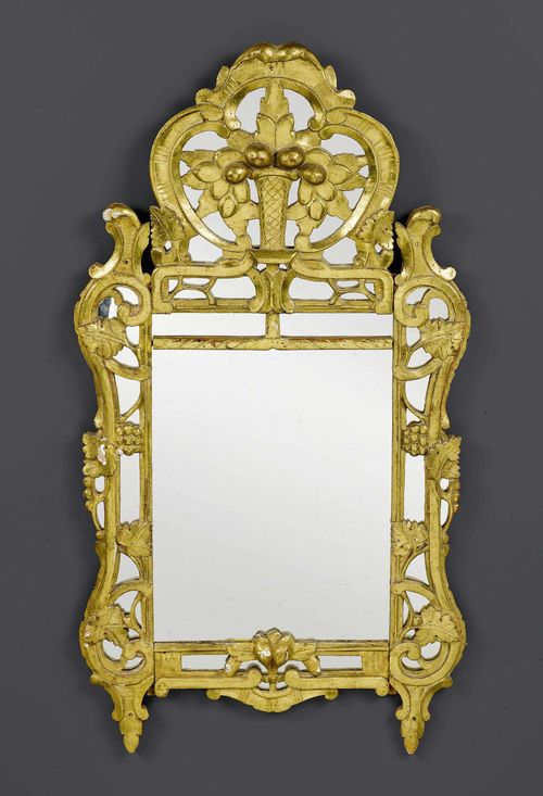 MIRROR,Louis XV, Provence circa 1760. Pierced and richly carved giltwood. Slightly chipped. H 126 cm. W 65 cm.
