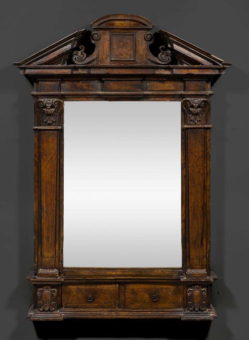 MIRROR,Renaissance, Tuscany, circa 1600. Shaped and richly carved walnut and burlwood. The base with 2 adjacent drawers. H 110 cm, W 76 cm.