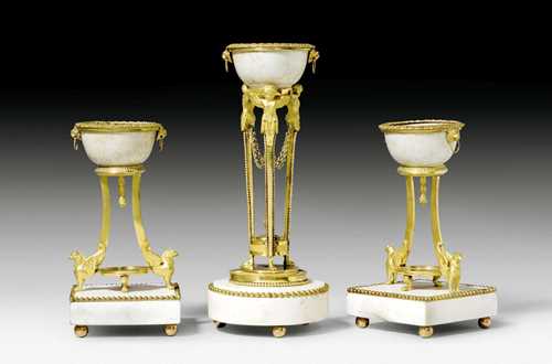 THREE-PIECE CELADON SET WITH BRONZE MOUNTS,Louis XVI, the celadon China, 18th century, the bronze Vienna circa 1780/90. Celadon, matt and polished gilt bronze and white marble. The smaller bowls each with 1 ducat with relief depiction of the Emperor Joseph II of Austria and inscription IOS. II.D.G.R.I.S.A.GE.HV.BO.REX (Joseph II, by the grace of God elected Holy Roman Emperor, forever August, King of Germany, Hungary and Bohemia"). H 31 cm and 22.5 cm. Provenance: from a French collection. A rare ensemble of high quality; expertise by Cabinet Dillee, Guillaume Dillee/Simon Pierre Etienne, Paris 2012.
