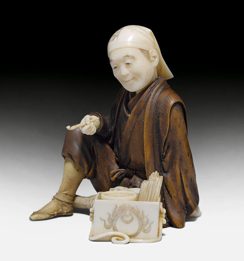 AN IVORY AND BOXWOOD OKIMONO OF AN INCENSE VENDOR.