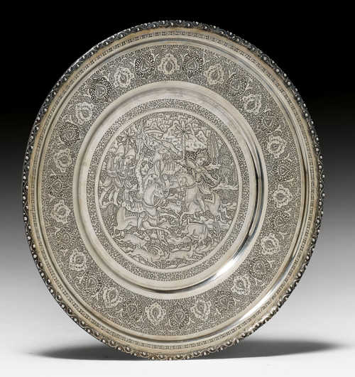 A SILVER PLATE ENGRAVED AND PUNCHED WITH A HUNTING SCENE WITHIN A BORDER OF FLORAL CARTOUCHES AND LEAFY VINES.