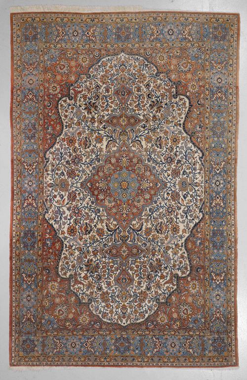 GHOM old.Bulky, white and rust coloured central medallion on a rust coloured ground, opulently patterned with trailing flowers and palmettes, blue edging, 227x345 cm.