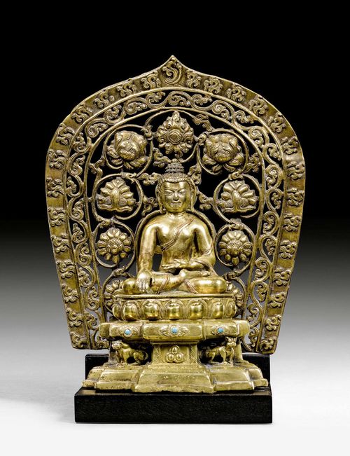 A FINE BRONZE FIGURE OF SHAKYAMUNI COMBINED WITH AN OPENWORK AUREOLE. Tibet, 14th/15th c. Height 16 cm. The aureole ca. 16th c. Height 21.5 cm.