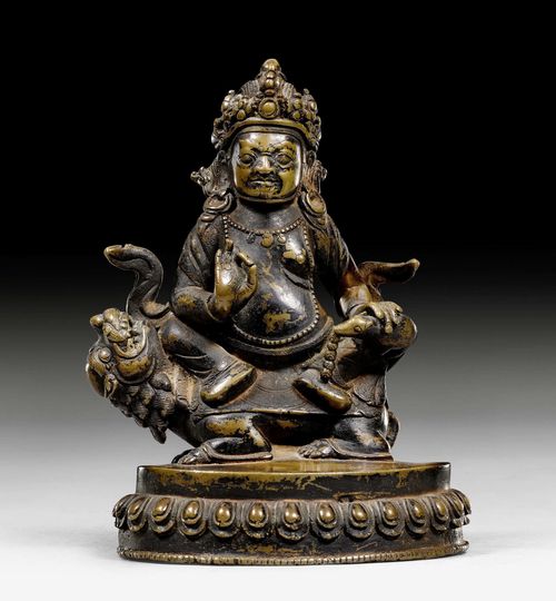 A COPPER ALLOY FIGURE OF VAISRAVANA SEATED ON A LION. Tibet, 17th c. Height 14 cm.