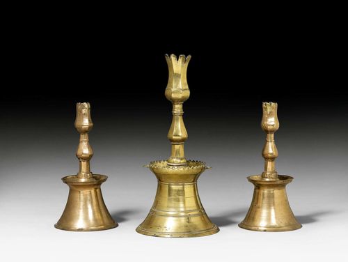 SET OF 3 SIMILAR CANDLESTICKS,Baroque, probably German, 18th century. Bronze. H 35 cm, and 26 cm.